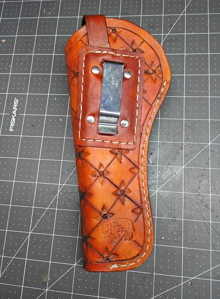 Pistol holster for auto-loader or revolver. Handmade for right handed use. Freehand engraved, monogrammed with heavy duty clip mount.