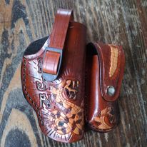 Handmade for left hand use. Freehand engraved and monogrammed, pistol holster for auto-loader or revolver with heavy duty clip mount.