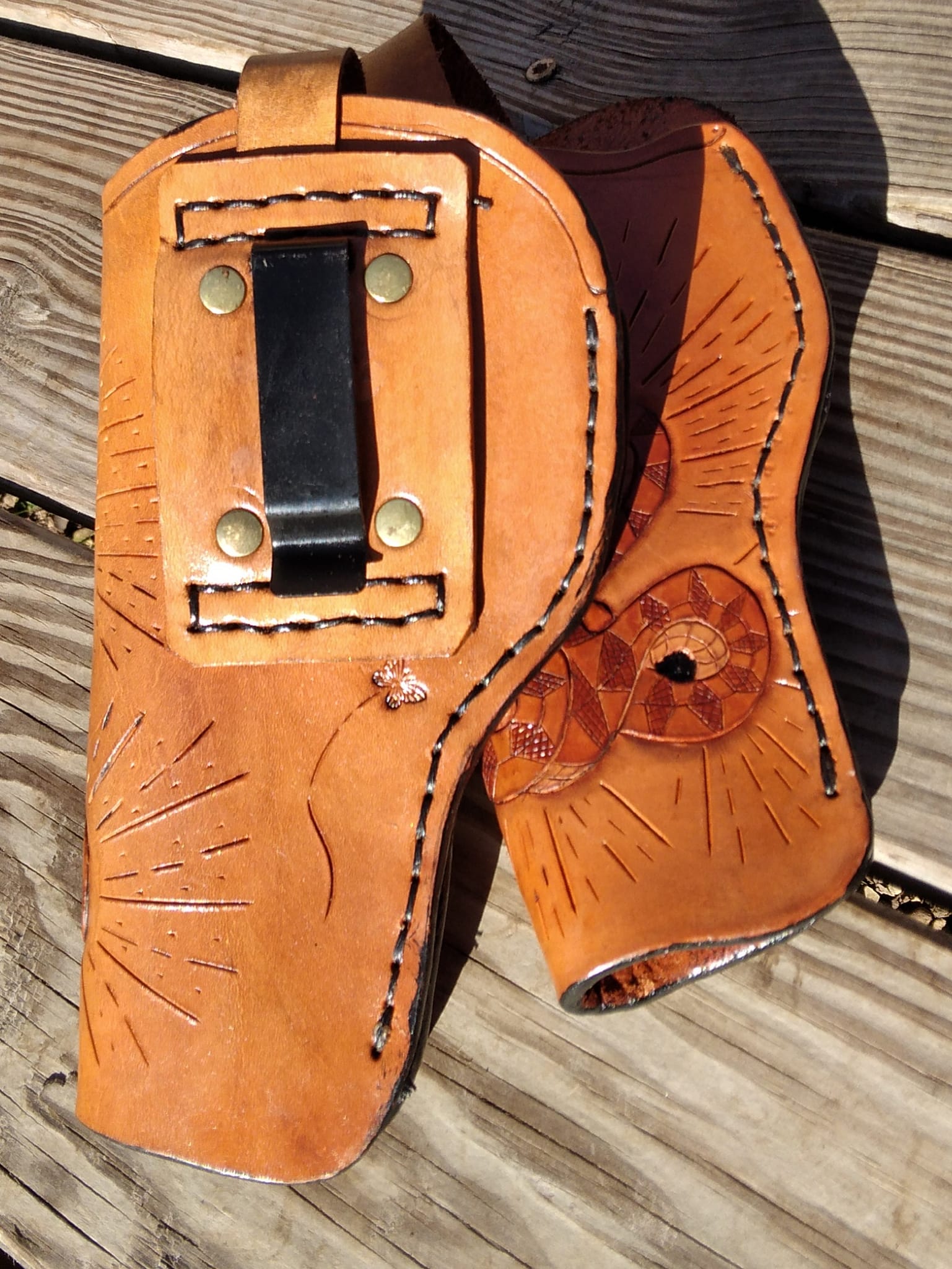 handmade leather holster for automatic or revolver with custom engraving.