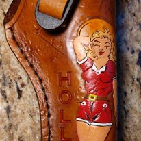 Handmade for left hand use. Freehand engraved and monogrammed, pistol holster for auto-loader or revolver with heavy duty clip mount.