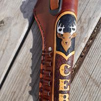 handmade leather holster for automatic or revolver with custom engraving.