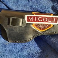 Handmade for left hand use. Freehand engraved and monogrammed, pistol holster for auto-loader or revolver with heavy duty clip mount.