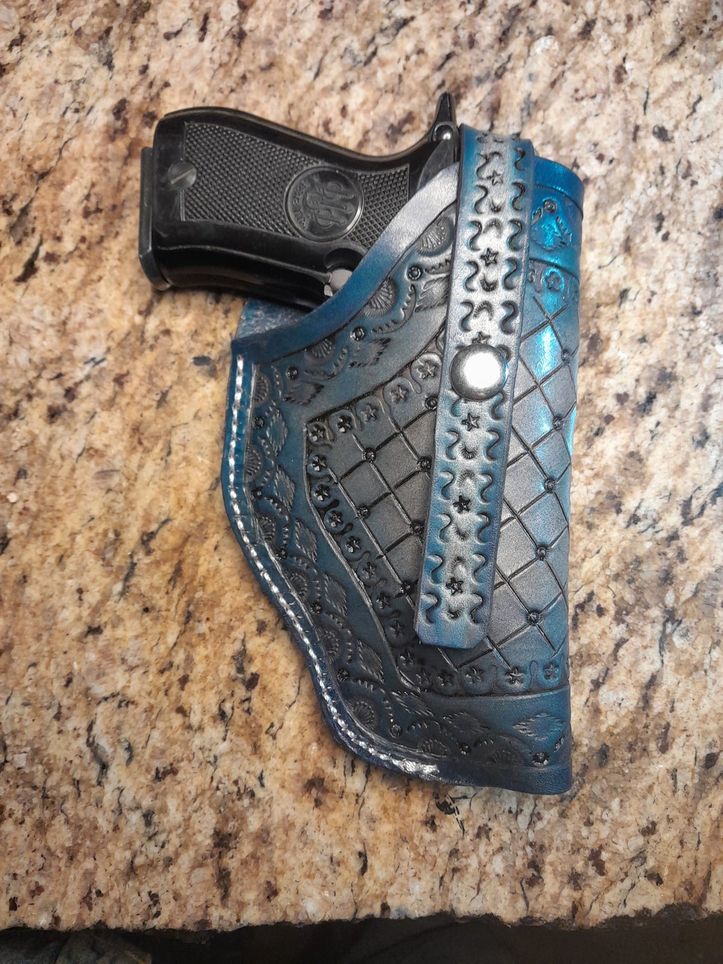 Pistol holster for auto-loader or revolver. Handmade for right handed use. Freehand engraved, monogrammed, and made from scratch.