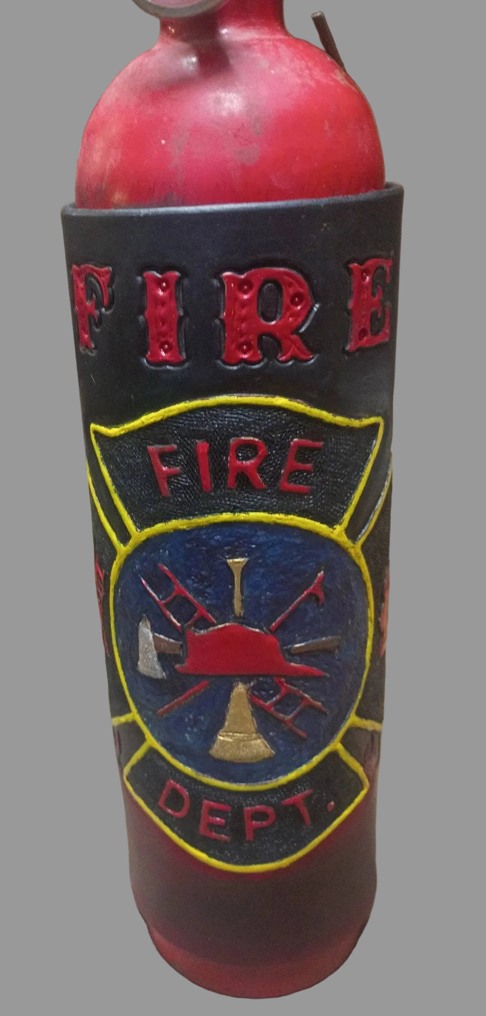 A red fire hydrant-shaped bottle or container with a black sleeve featuring embossed 'FIRE DEPT.' text and a yellow, blue, and red firefighter emblem, shown on a rustic wooden surface.