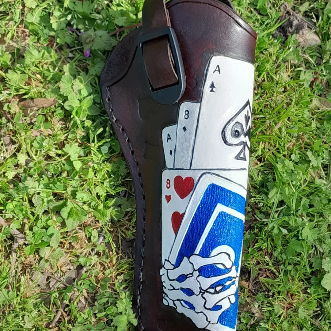 handmade leather holster for automatic or revolver with custom engraving.