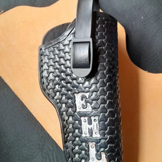 Handmade for left hand use. Freehand engraved and monogrammed, pistol holster for auto-loader or revolver with heavy duty clip mount.