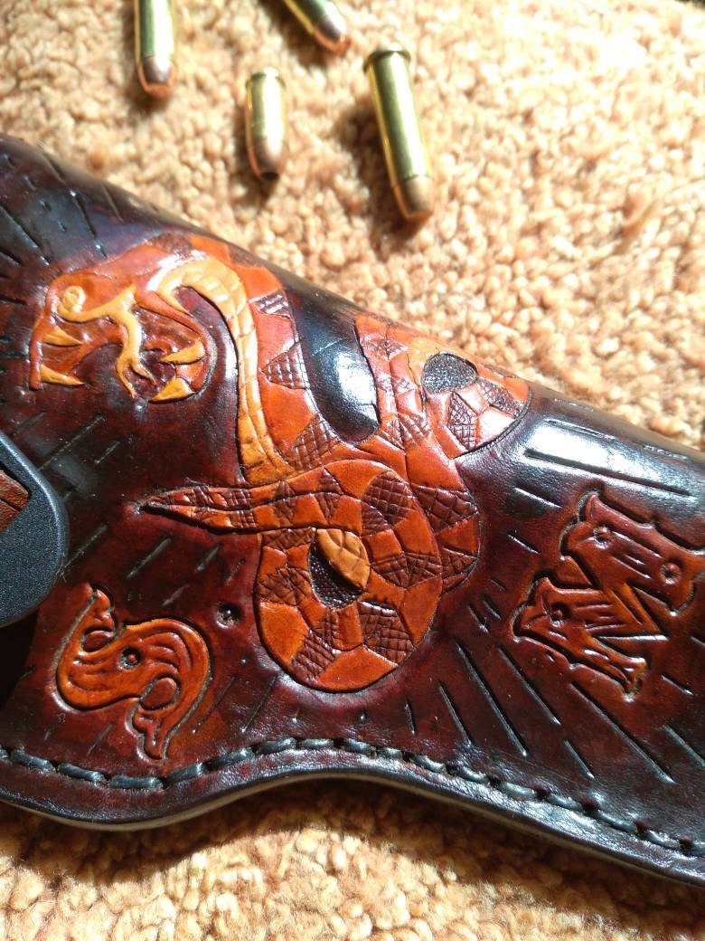 Handmade for right hand use. Freehand engraved and monogrammed, pistol holster for auto-loader or revolver with belt loop mount