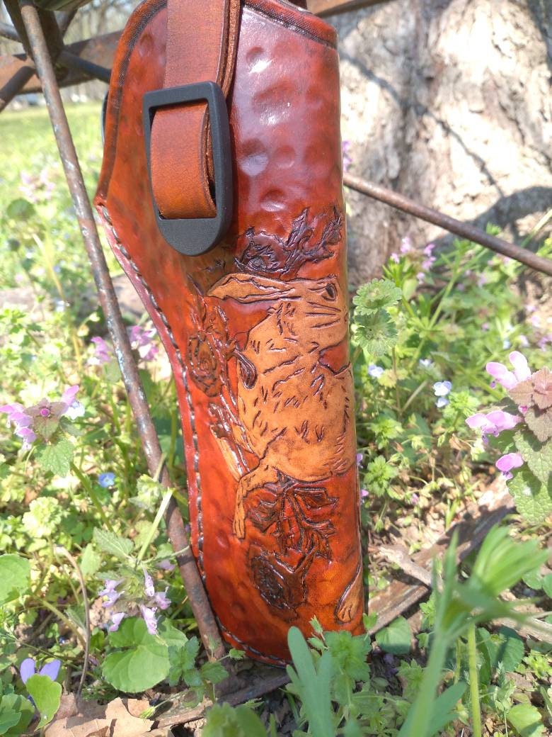 Handmade for left hand use. Freehand engraved and monogrammed, pistol holster for auto-loader or revolver.