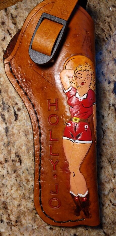 Pistol holster for auto-loader or revolver. Handmade for right handed use. Freehand engraved, monogrammed, and made from scratch.